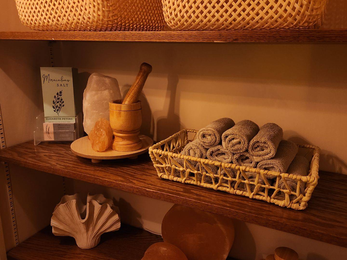 Rock salt, rolled hand towels and my business cards on a shelf
